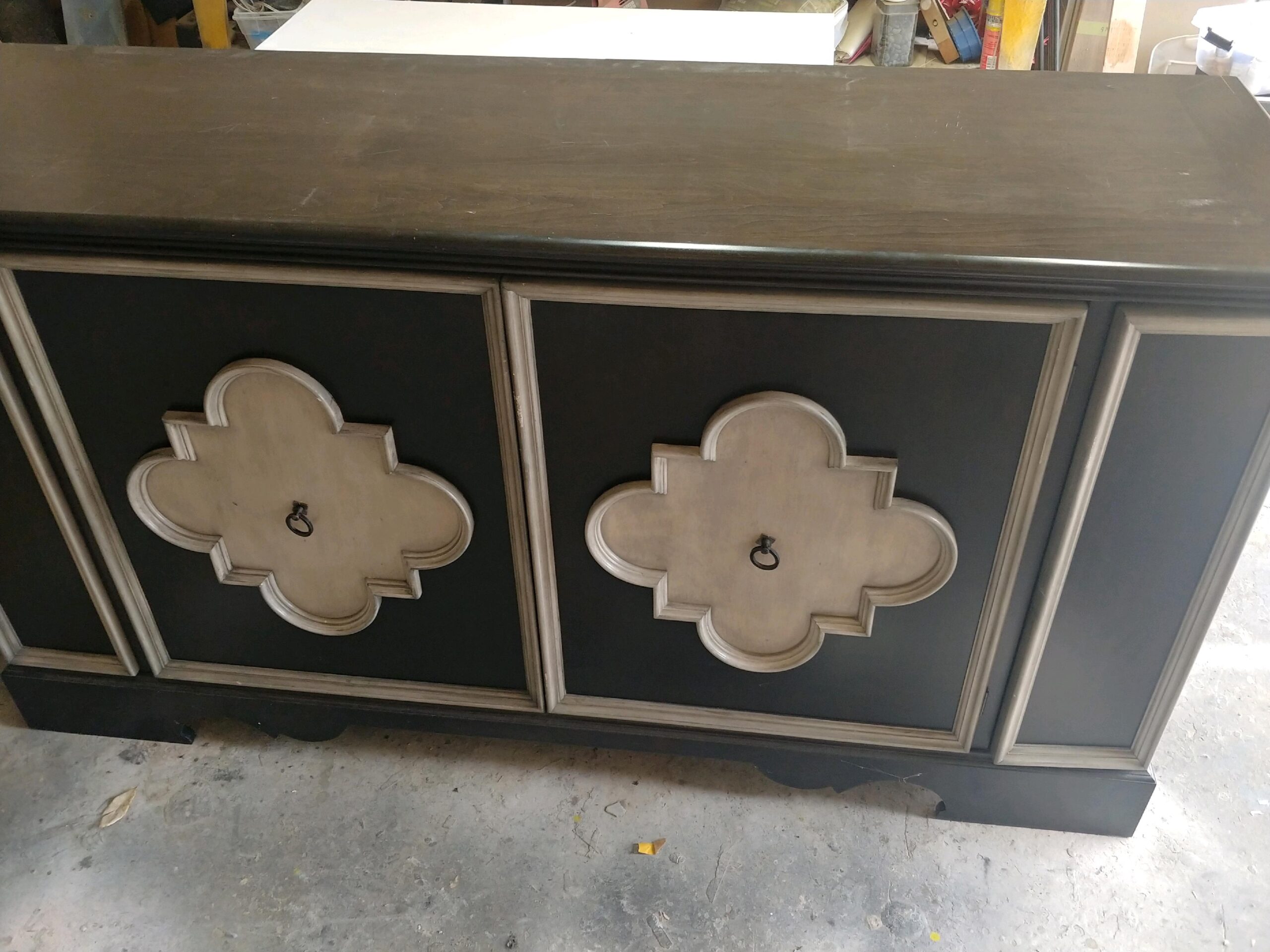 Quatrefoil cabinet finished in black and taupe