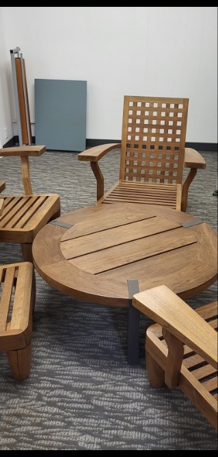 Outdoor teak patio set after refinishing, restored honey tone