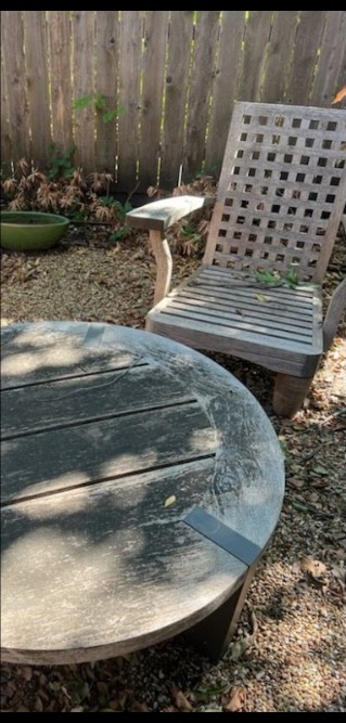 Outdoor teak patio set before refinishing, weathered gray