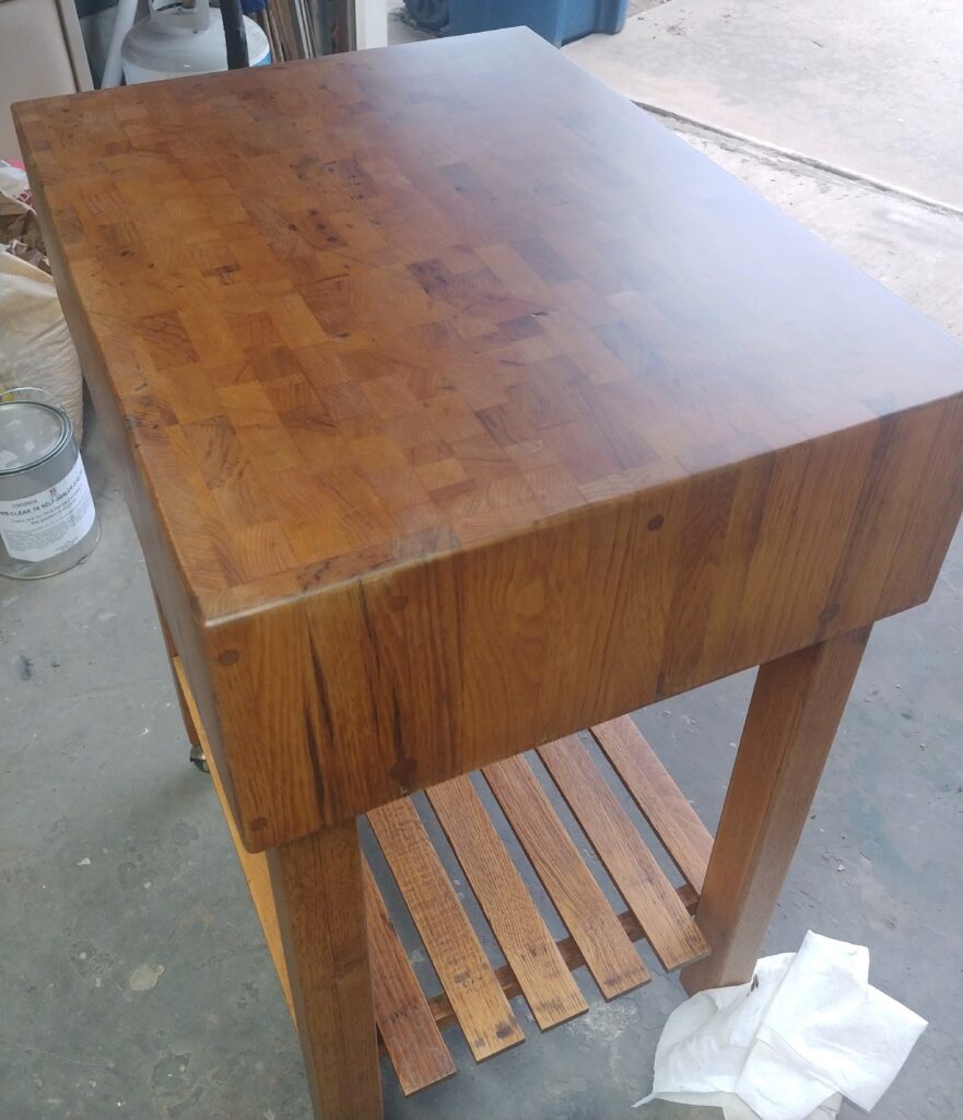 Restored end-grain oak butcher block top showing the recovered checkerboard grain pattern