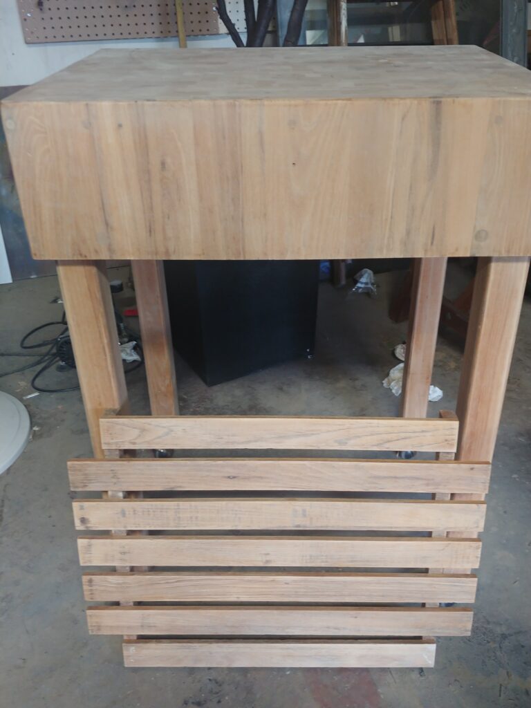 End-grain butcher block cart stripped and sanded back to bare pale oak, shelf slats removed, mid-restoration