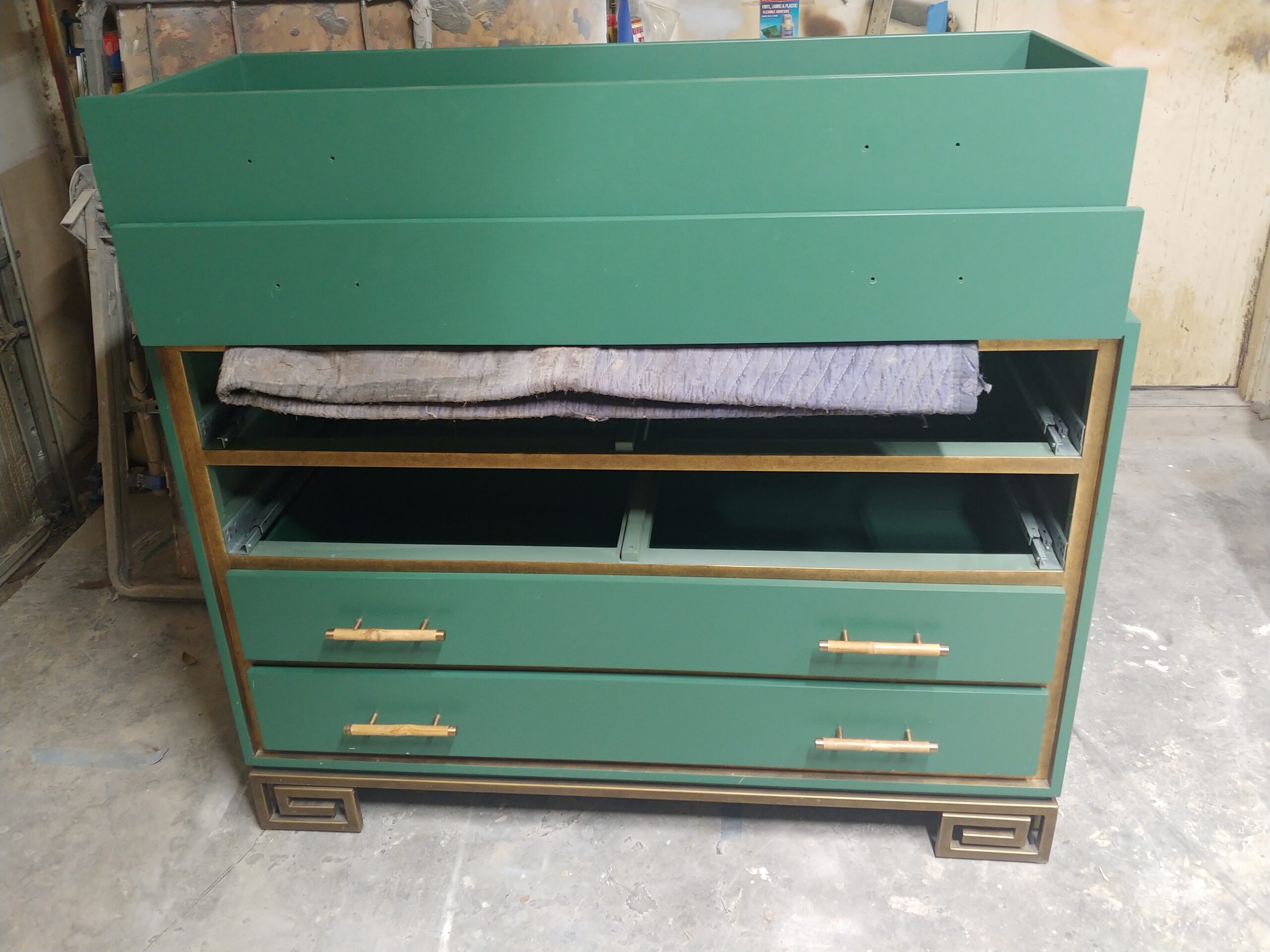 Gold leaf-trimmed dresser in hunter-green lacquer before refinishing