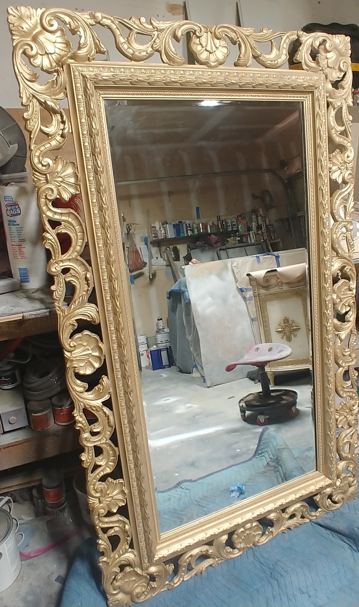 Carved mirror frame after Roman gilding, finished in gold to match the demilune cabinet