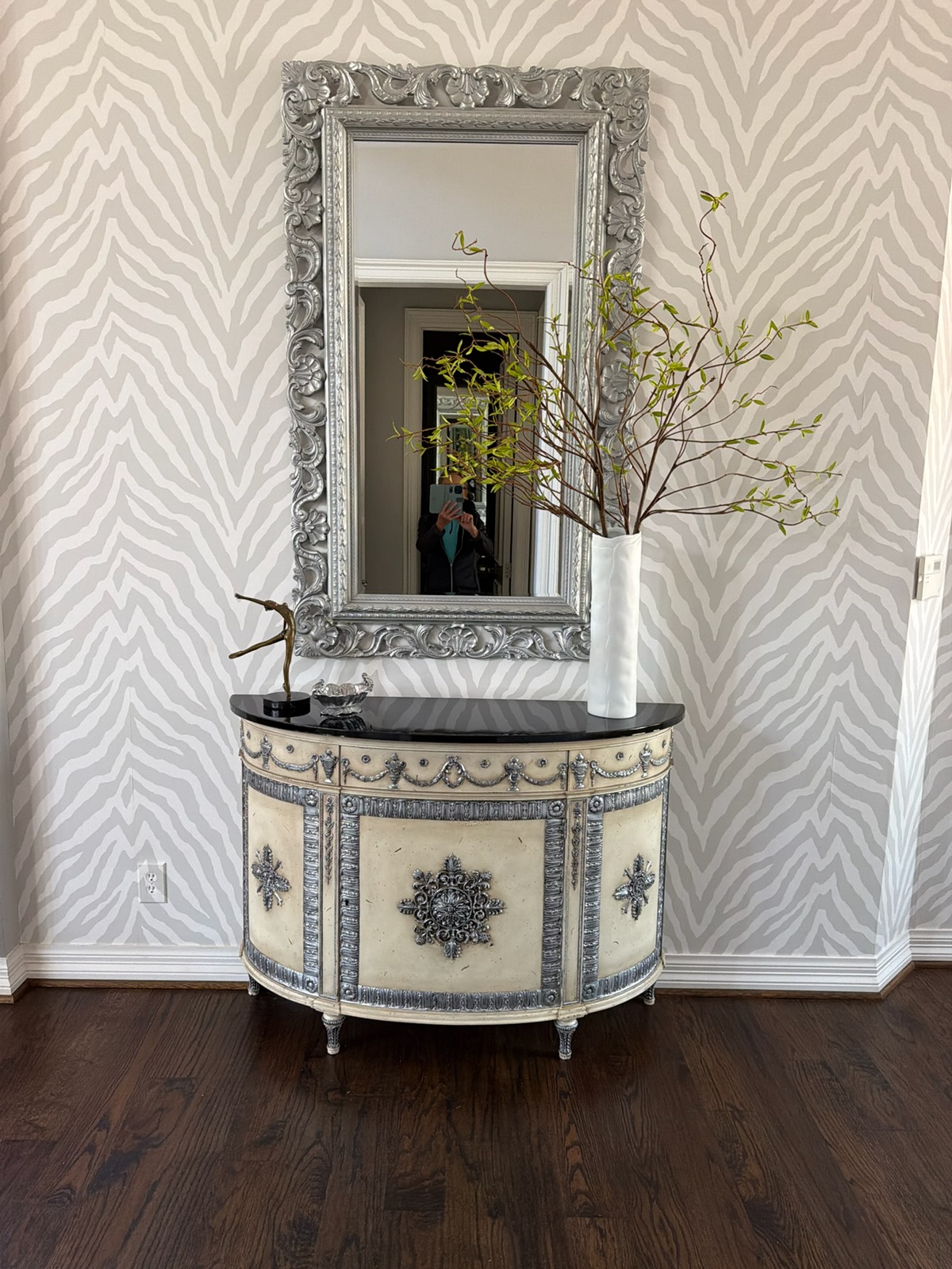 Before Roman gilding: carved mirror frame and demilune cabinet with flat silver painted details